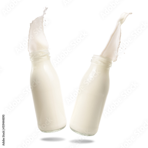 Milk splash out of bottle isolated on white background.