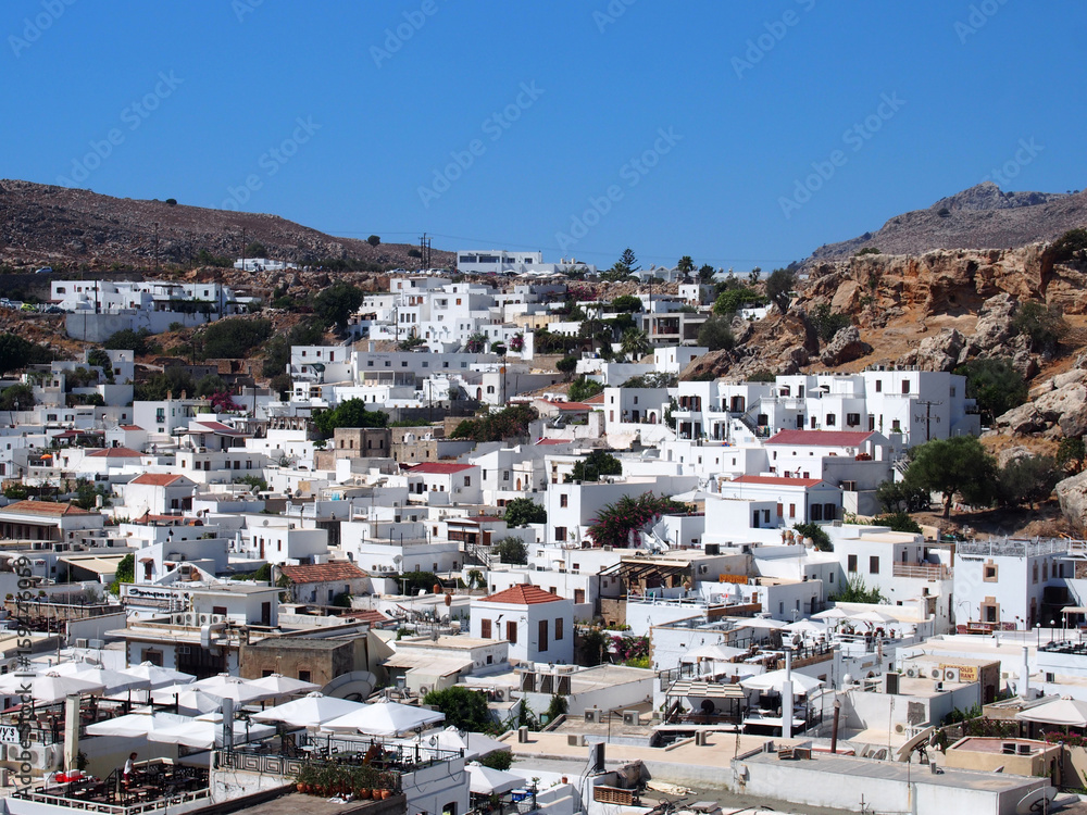 view of afandou village in rhodes with blue sky and mountains
