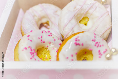 White icing doughnuts in decorated gift box