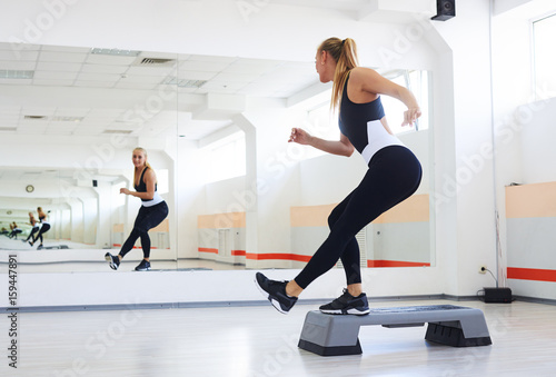 Athlete having a step aerobics in a gym