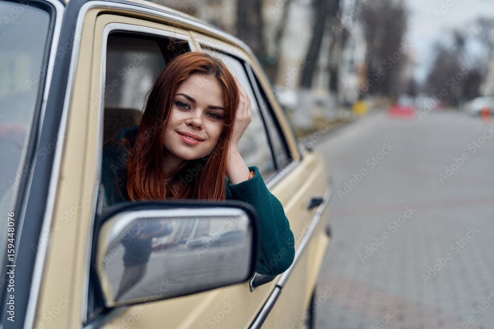Woman driving, woman peeking out of car window Woman driving, woman peeking out of car window