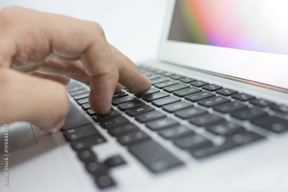 Closeup of a man's hand using a laptop. Silver aluminum body. A beautiful modern laptop. A keyboard of a laptop isolated on a white background. Lens flare in the background.
Closeup of a man's hand using a laptop. Silver aluminum body. A beautiful modern laptop. A keyboard of a laptop isolated on a white background. Lens flare in the background.