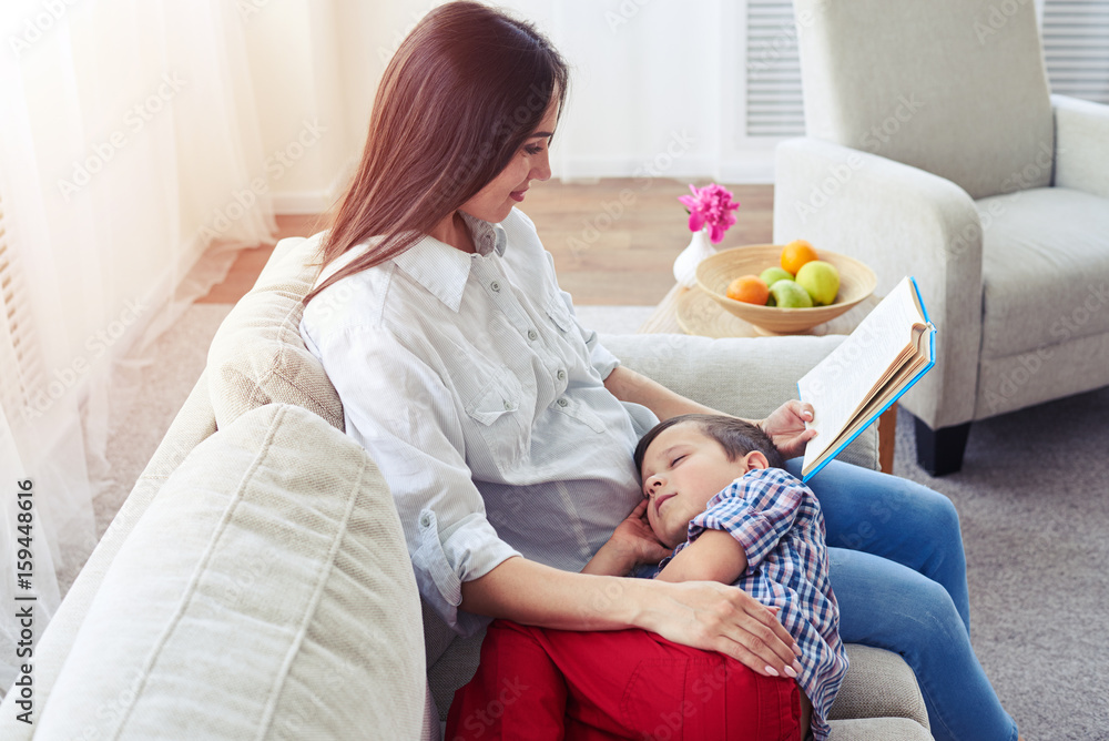 Mother reading a story to her son Mother reading a story to her son
