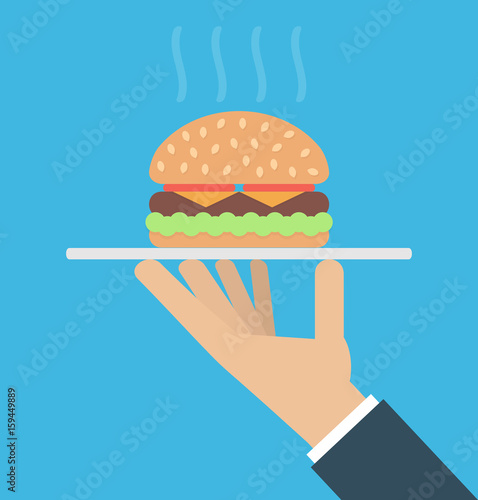  Hand holding a platter with a big hamburger on it