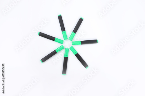 Green markers on a white background