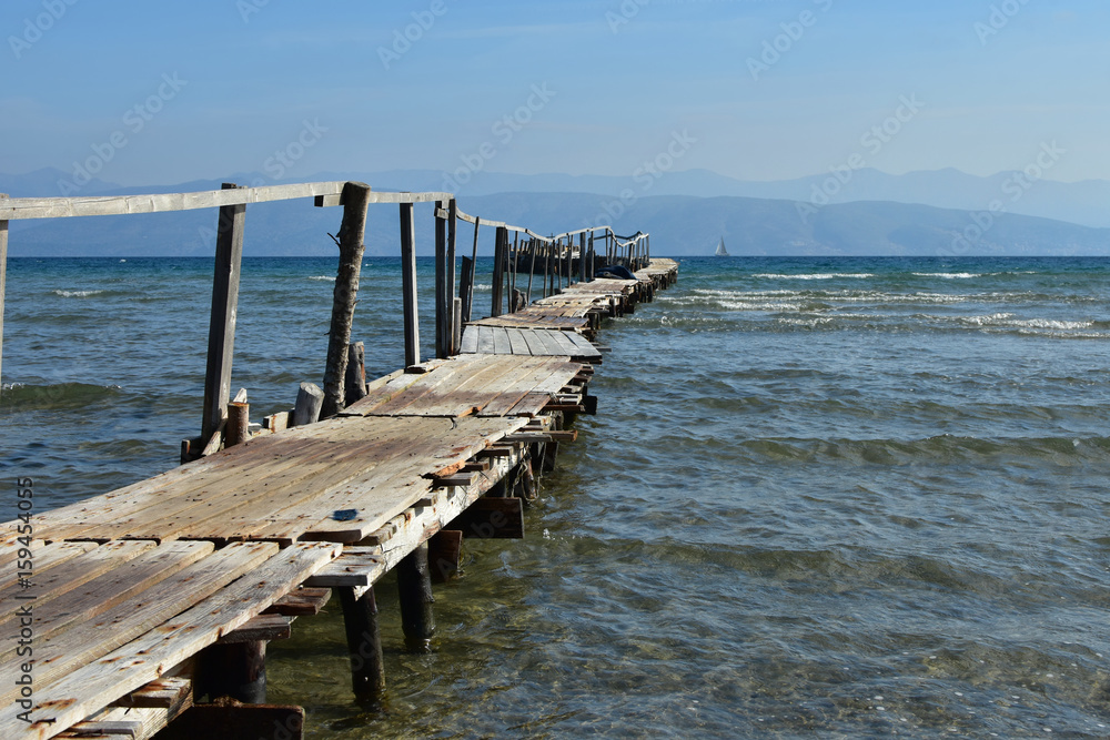 Naklejka premium Old wooden mooring dock for fishing boats, Corfu Island, Greece