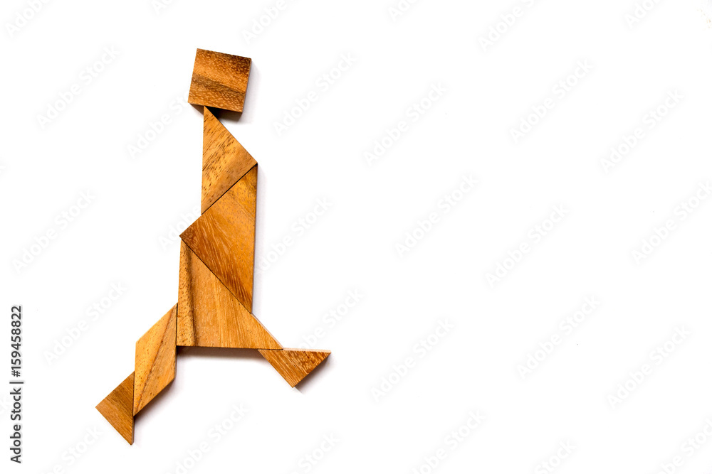 Wooden tangram puzzle in walking man shape on white background Wooden tangram puzzle in walking man shape on white background