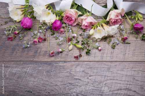 Festive flower composition on the old wooden background. Overhead view. © Olga Ionina