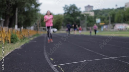 Wallpaper Mural A young girl is running at the stadium. Playing sports. Girl running sport. Torontodigital.ca