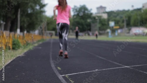 Wallpaper Mural A young girl is running at the stadium. Playing sports. Girl running sport. Torontodigital.ca