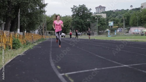 Wallpaper Mural A young girl is running at the stadium. Playing sports. Girl running sport. Torontodigital.ca