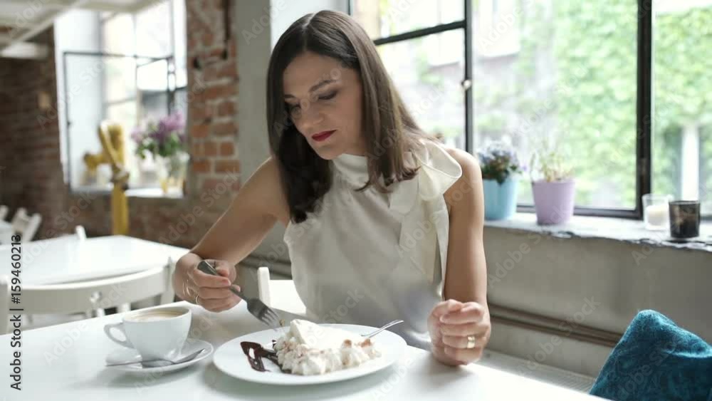 Elegant woman eating delicious cake in the restaurant, steadycam shot
Elegant woman eating delicious cake in the restaurant, steadycam shot