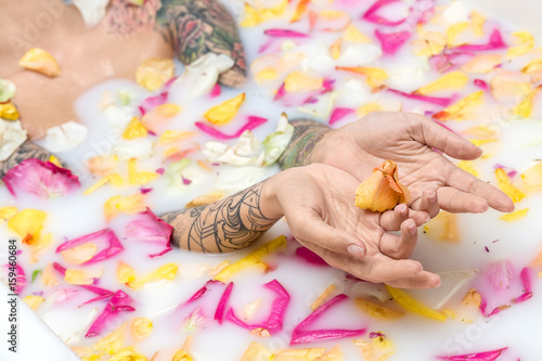 Tattooed girl relaxing in bath