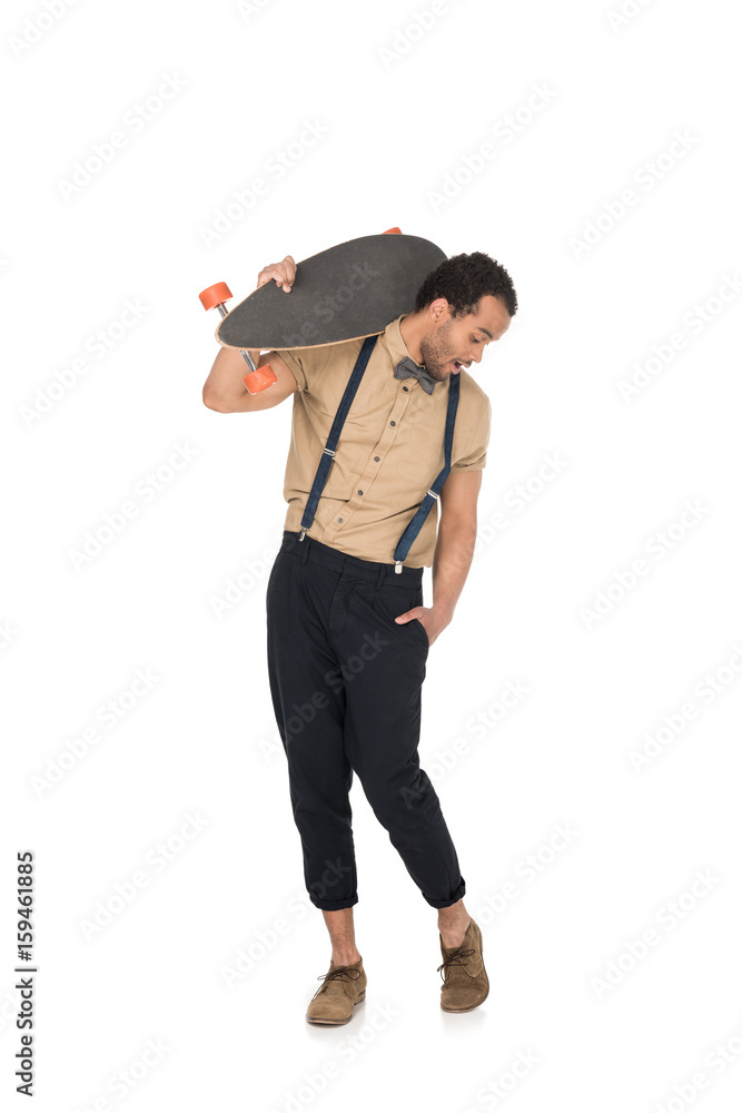 Surprised young stylish man holding skateboard on shoulder and looking down Surprised young stylish man holding skateboard on shoulder and looking down
