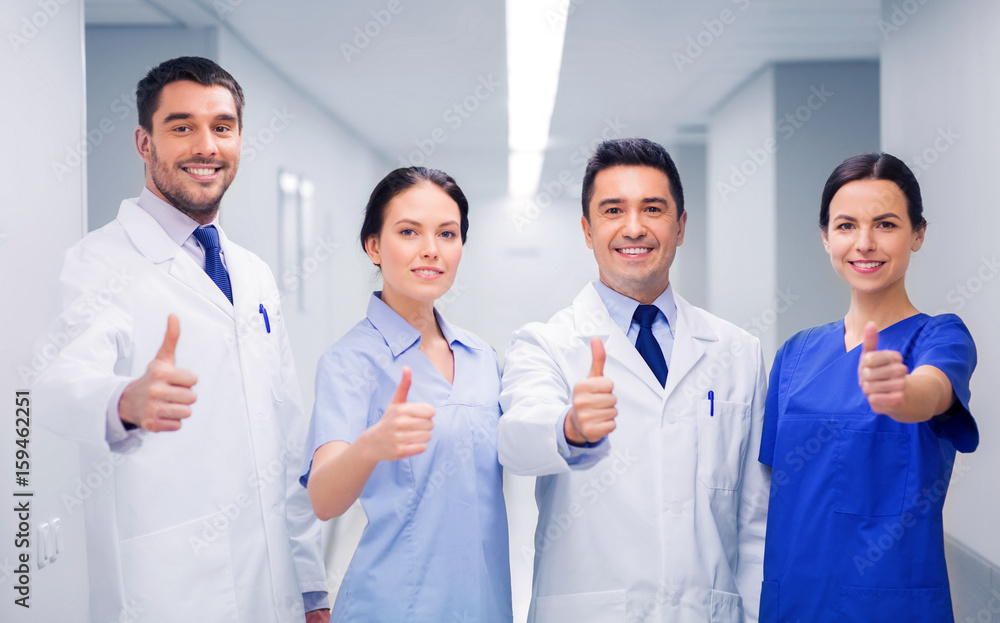 medics or doctors at hospital showing thumbs up medics or doctors at hospital showing thumbs up