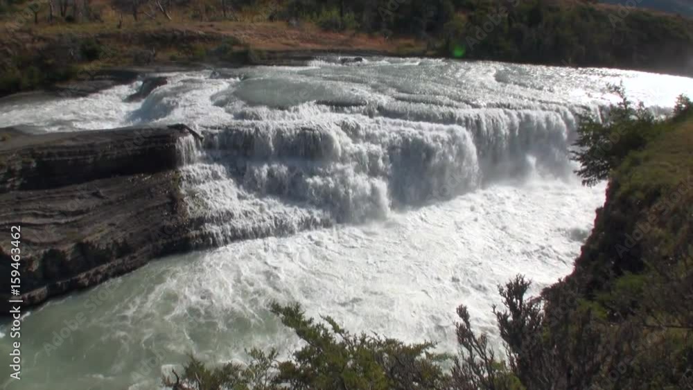 Rapids of mountain river show power water in Patagonia Argentina. Unique landscape of wildlife. Beautiful nature background. Travel and tourism in picturesque world of stone rocks and hills. Rapids of mountain river show power water in Patagonia Argentina. Unique landscape of wildlife. Beautiful nature background. Travel and tourism in picturesque world of stone rocks and hills.
