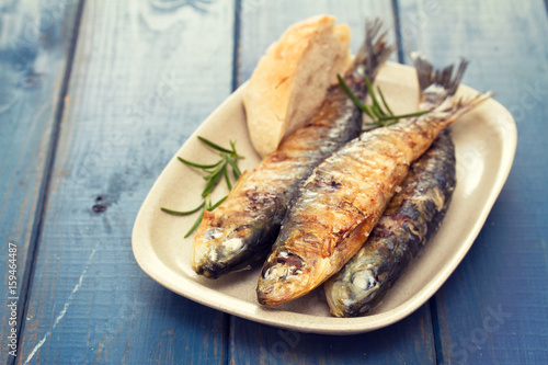 grilled sardines with bread on dish