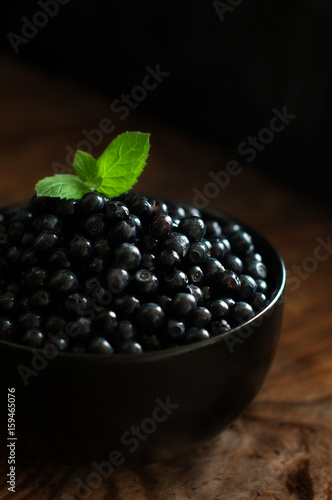 blueberries in round ceramic bowl on wooden table