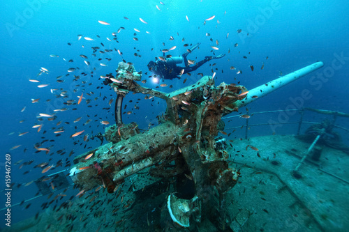 ship wreck in tropical sea ,cannon tower of a sunken ship with scuba diver,H.T.M.S. Prab Wreck Dive, Koh Ngam Noi Island , Chumphon Province Thailand