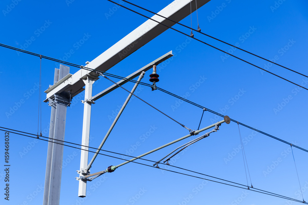 Overhead lines on Dutch railway over blue sky Overhead lines on Dutch railway over blue sky
