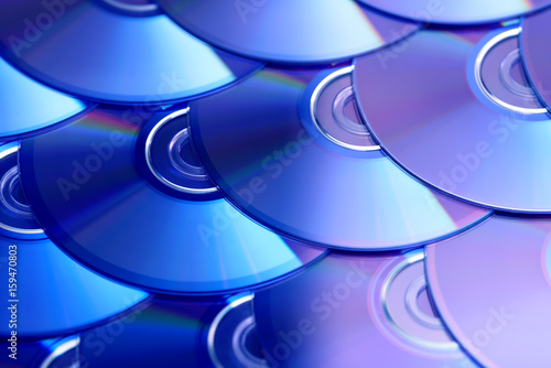 Compact discs background. Several cd dvd blu-ray discs. Optical recordable or rewritable digital data storage. photo