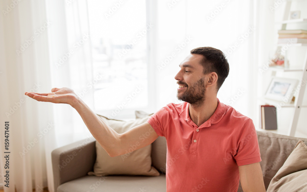happy man holding something imaginary at home happy man holding something imaginary at home