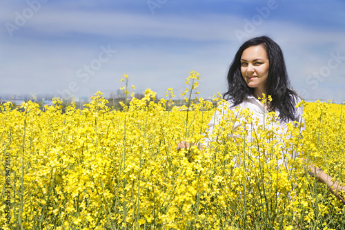 girl in suit at the yellow flower field