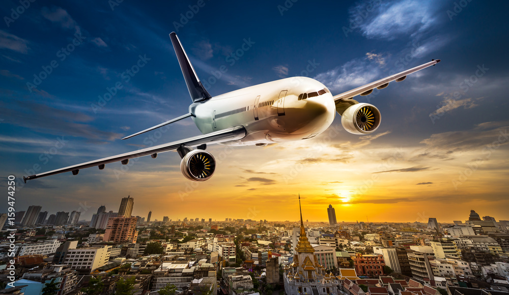 Obraz premium Airplane over city