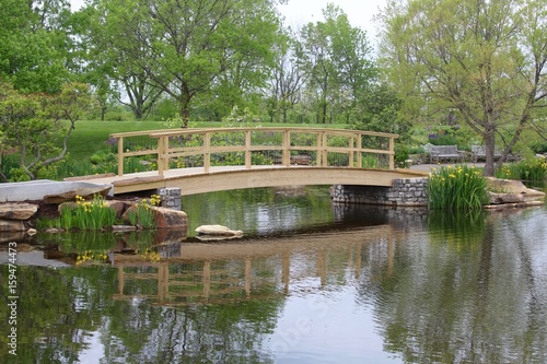 The wood bridge over the pond at the park.