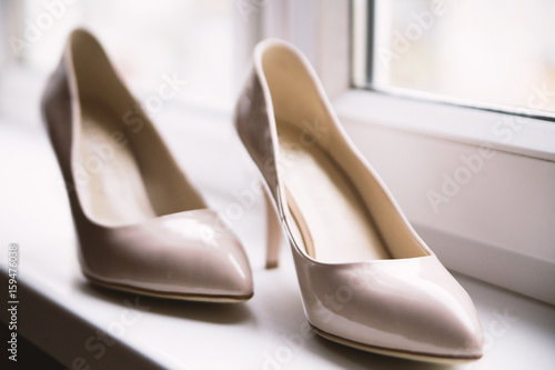 Wedding shoes by the window. Wedding charges