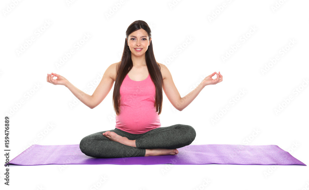 Young beautiful pregnant woman doing yoga exercise isolated on white