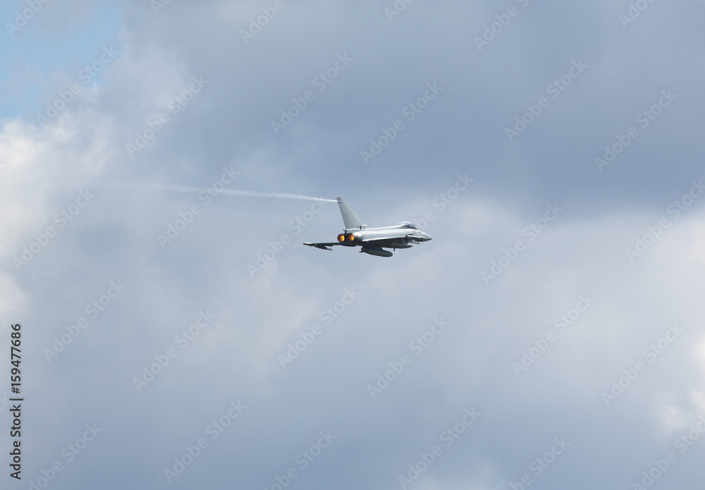 Modern jet fighter going full speed. Afterburner glowing orange. Modern jet fighter going full speed. Afterburner glowing orange.