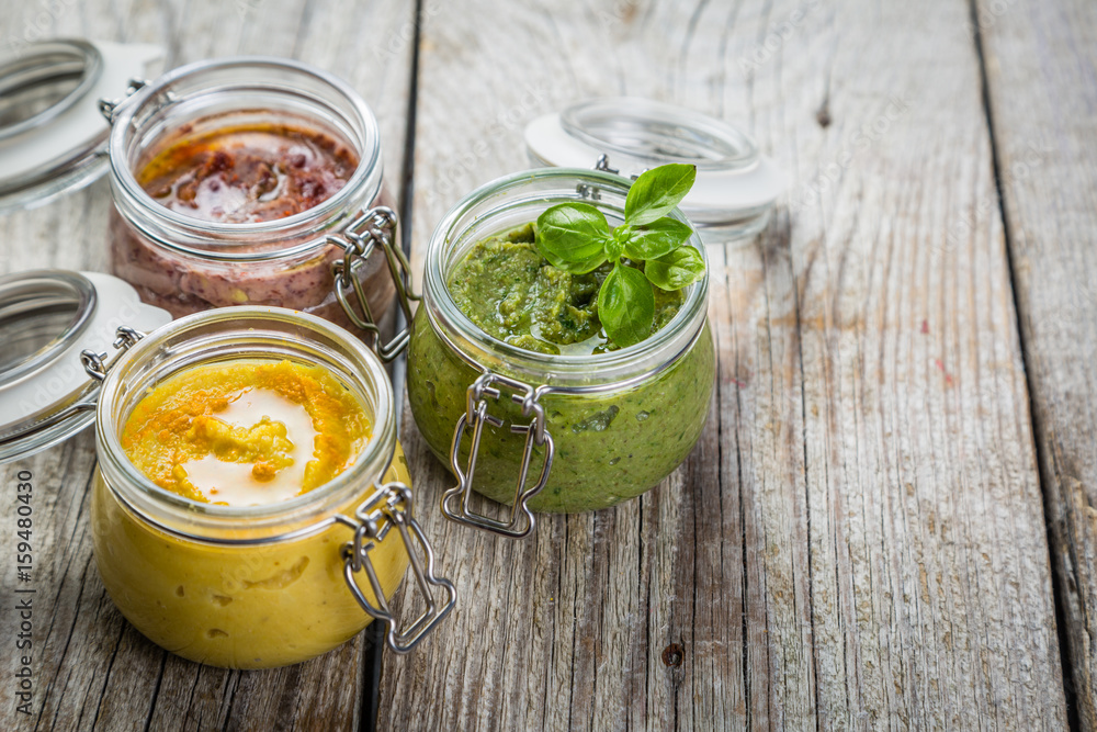 Selection of colorful hummus in jars Selection of colorful hummus in jars