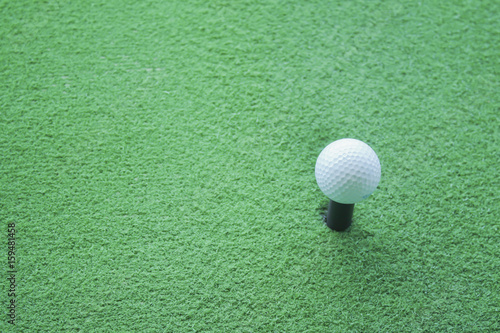 Golf ball on tee ready to be shot at a drivingrange