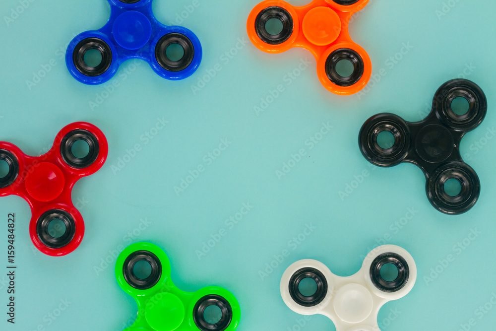 fidget spinners frame on blue background with copy space popular