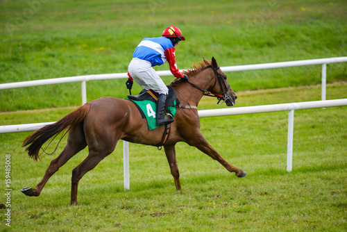 Jockey and race horse riding towards the finish line