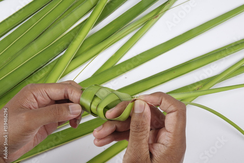 Making of Ketupat, a natural rice casing made from young coconut leaves for cooking rice