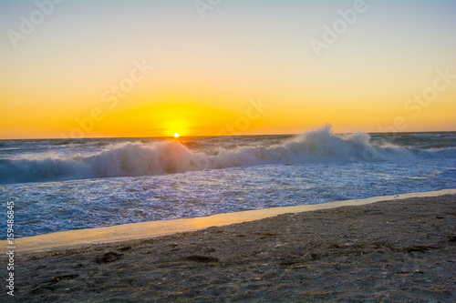 ocean sunset latge golden ball setting to ocean  photo