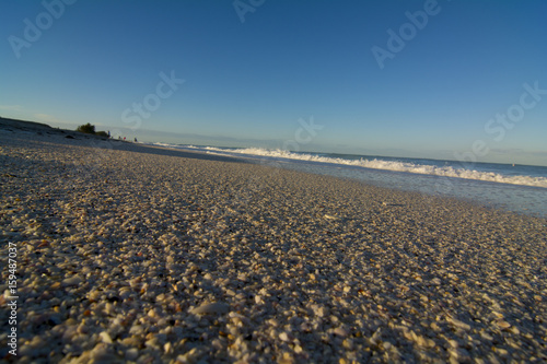 sandy beach with low tidel rolling in  © kevin