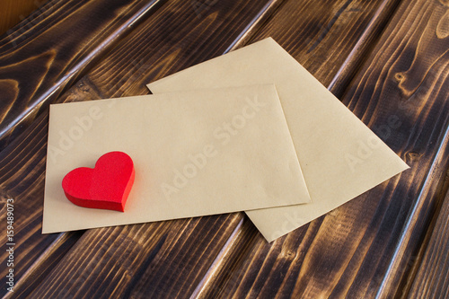 Obraz na plátně Two envelops and heart on the wooden background