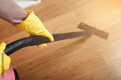 Female hands in rubber gloves hlods brush cleaner