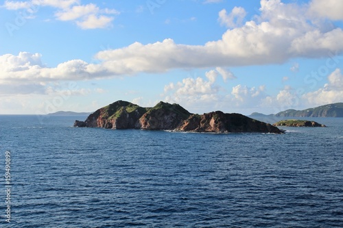 Small island off the coast of St. Thomas with clouds in the sky