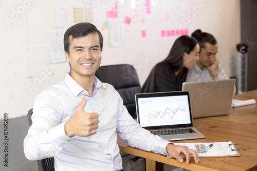 Businessman using laptop for working with attractive smiling  at workplace, businesspeople working concept. photo