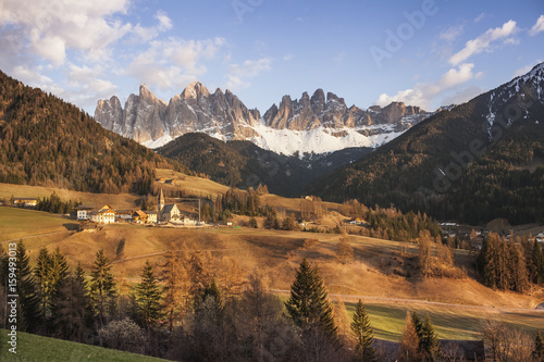 View on Dolomities in Trentino Alto Adige, Italy at sunset with Santa Magdalena Village in the foreground, selective focus. © Lyudmila