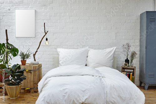 vintage urban bedroom white bedspread green plants and warm colors