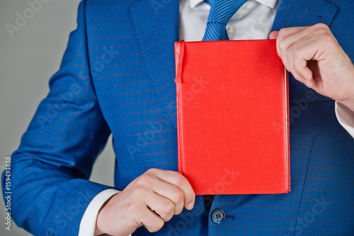 business man with red book in hand, marketing
