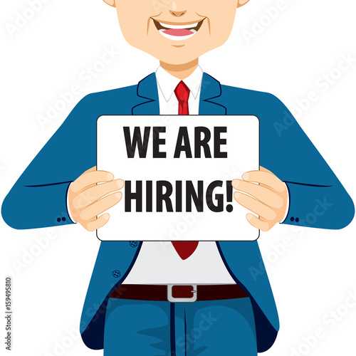 Businessman holding white banner with We Are Hiring text