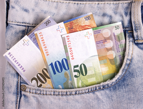 Closeup of the swiss notes in the jeans pocket.