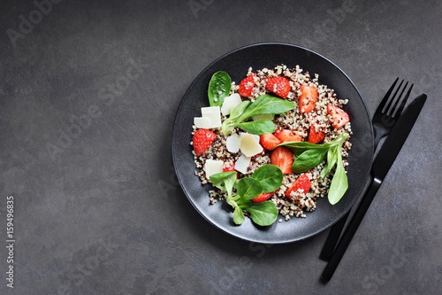 Quinoa salad with strawberry and parmesan cheese. Overhead view. Copy space