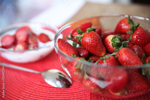 ripe red strawberry in a transparent plate photo